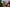 Man standing outside during the day by his house on his front lawn holding his silver telescoping flag pole