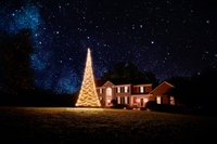 Thumbnail for Warm white LED Christmas tree for flagpole, illuminated at night, featuring a festive design. By Atlantic Flagpole.