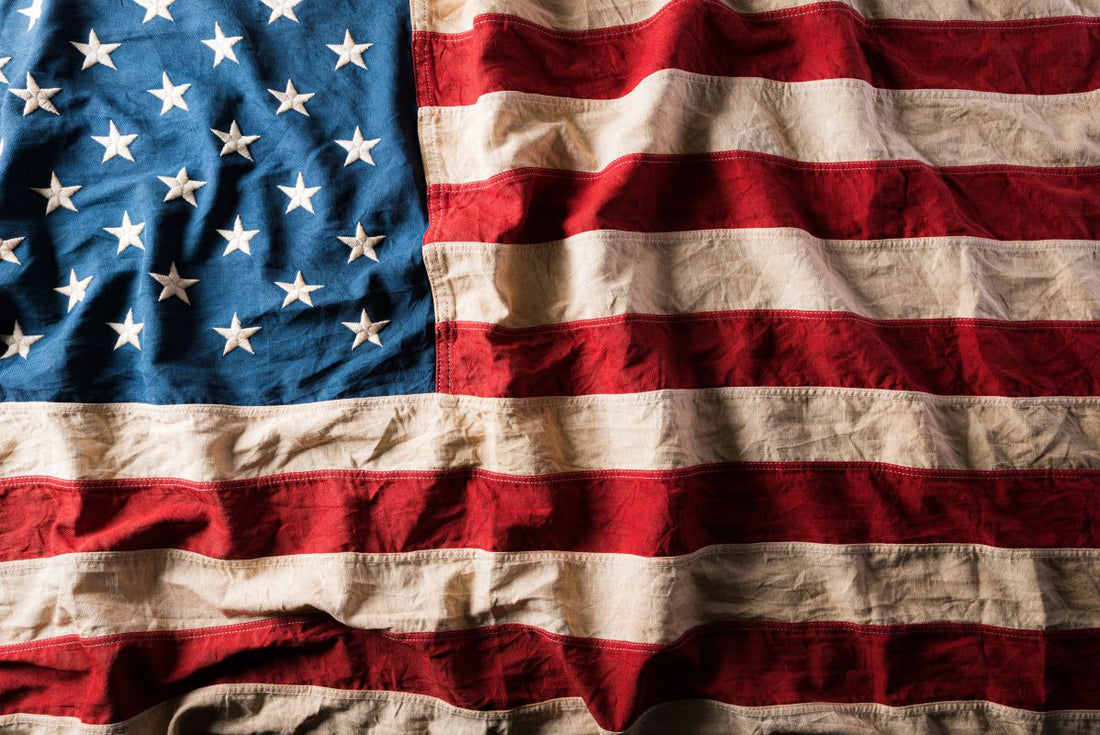 Waving American flag with vibrant blue, red, and white colors, showcasing stars and stripes for 4th of July celebrations.