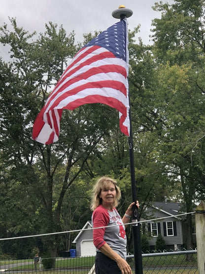 White solar flagpole lighting system from Atlantic Flagpole, designed for bright illumination of flags.