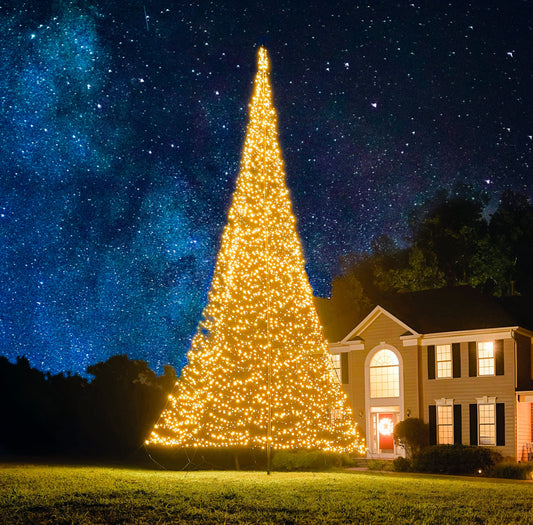 Warm white LED Christmas tree on a flagpole, 40’-43’, by Atlantic Flagpole, glowing against a night sky.