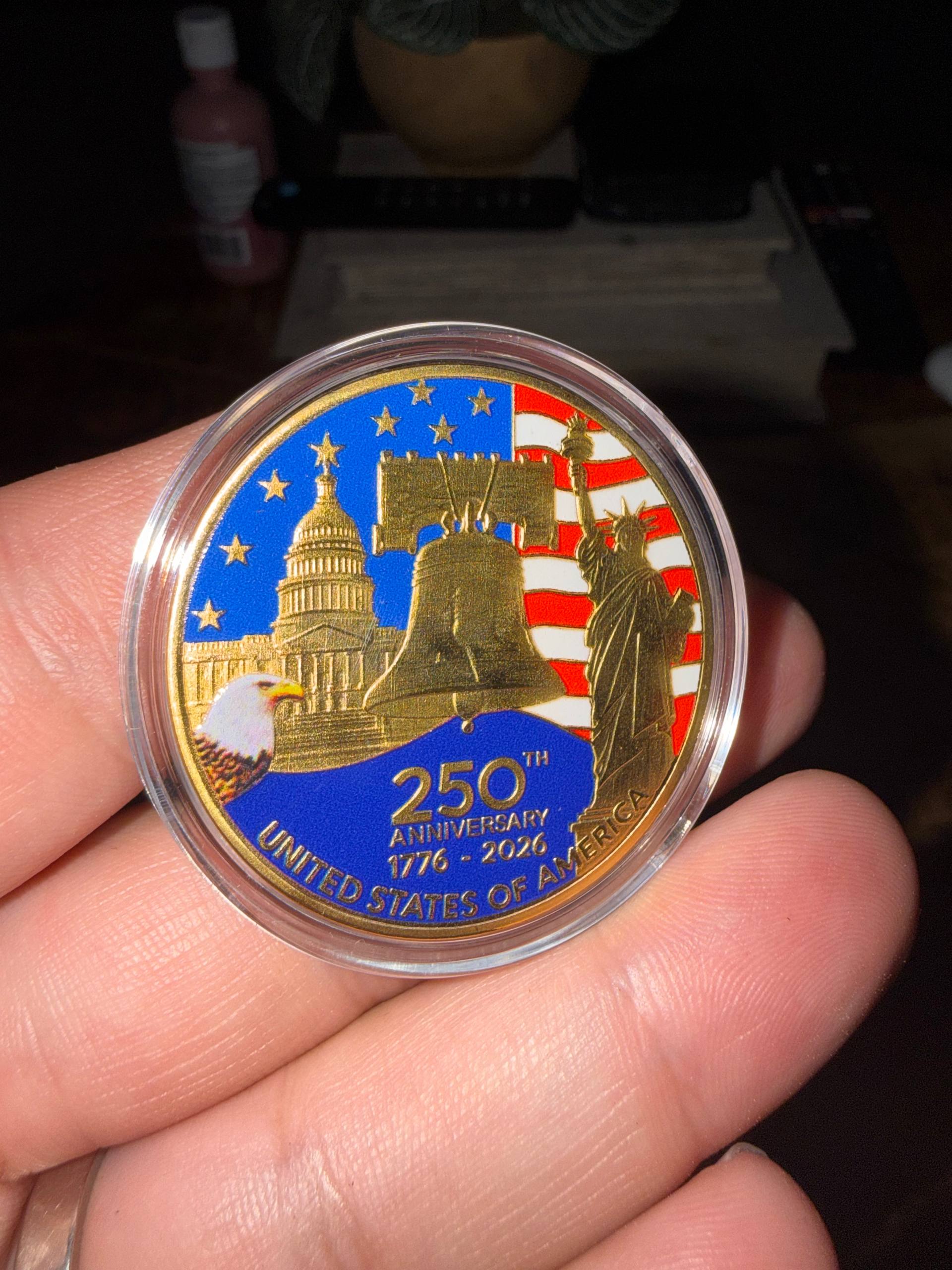 America 250 Challenge Coin held in hand for size reference