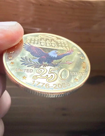 America 250 Challenge Coin reverse eagle design shown at an angle on a wood tabletop