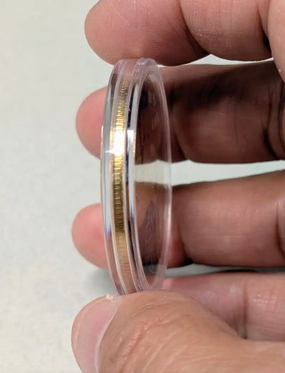 America 250 Challenge Coin side thickness shown held in fingers