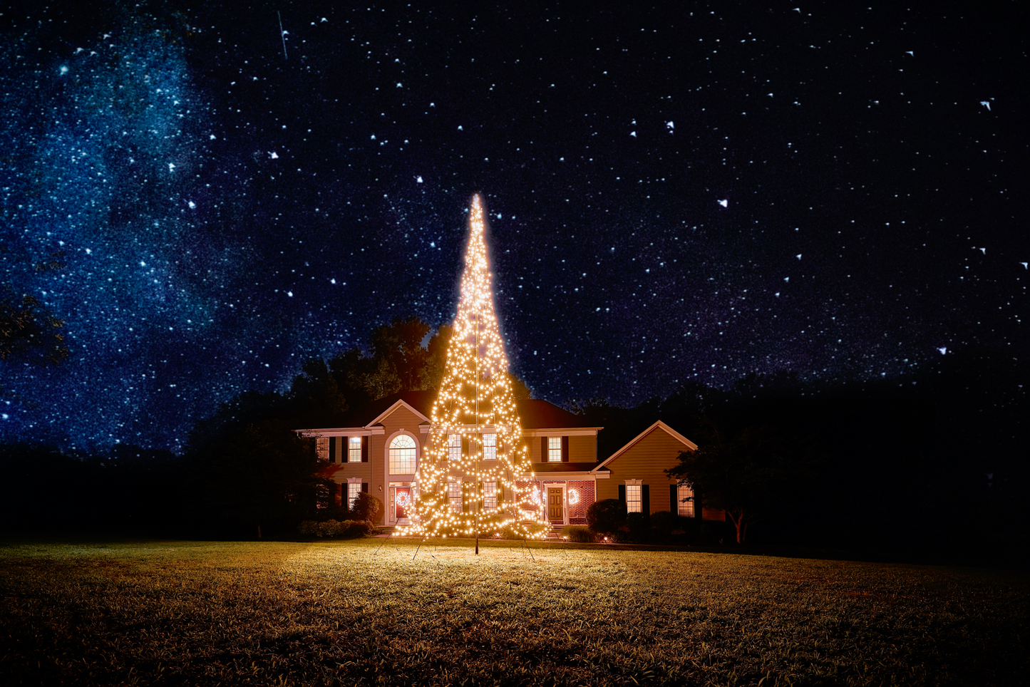 Warm white LED Christmas tree lights on 20' flagpole, displayed outside a house, by Atlantic Flagpole.