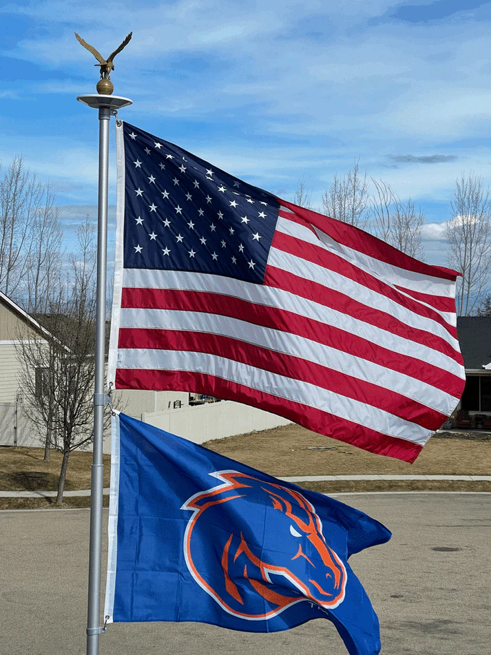A Phoenix telescoping flagpole flying the American flag at a customer's home
