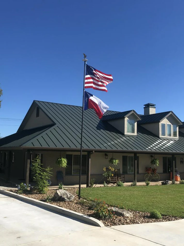 A Phoenix telescoping flagpole flying the American flag at a customer's home