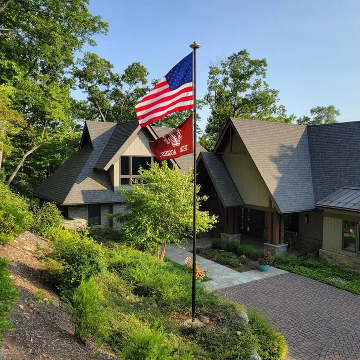 A Phoenix telescoping flagpole flying the American flag at a customer's home