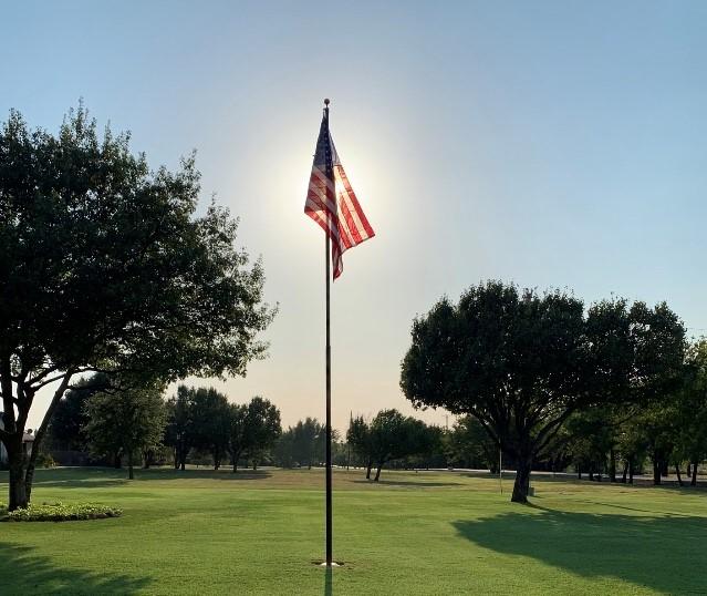 A Phoenix telescoping flagpole flying the American flag at a customer's home