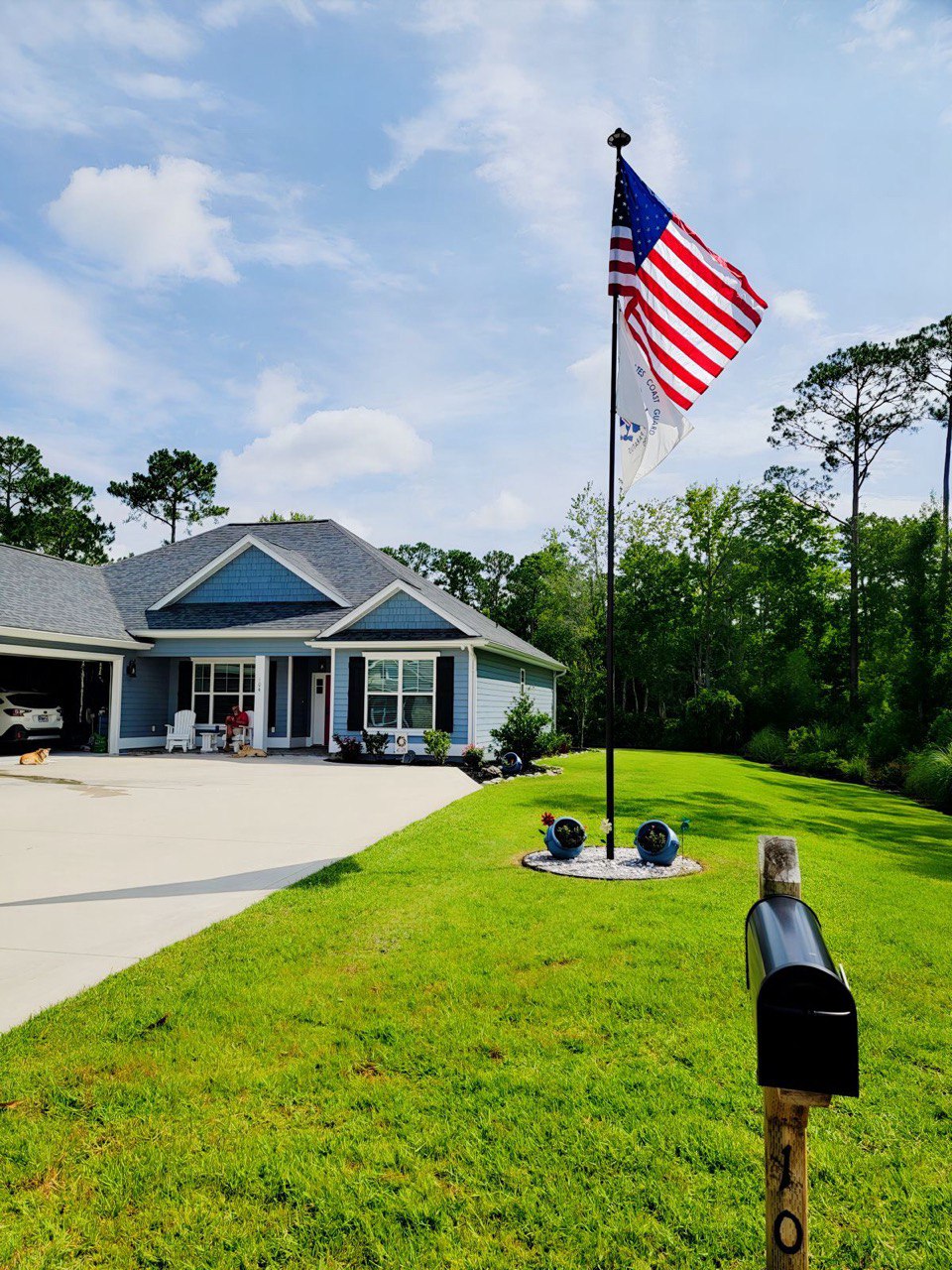 A Phoenix telescoping flagpole flying the American flag at a customer's home