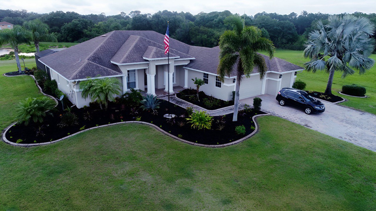 A Phoenix telescoping flagpole flying the American flag at a customer's home