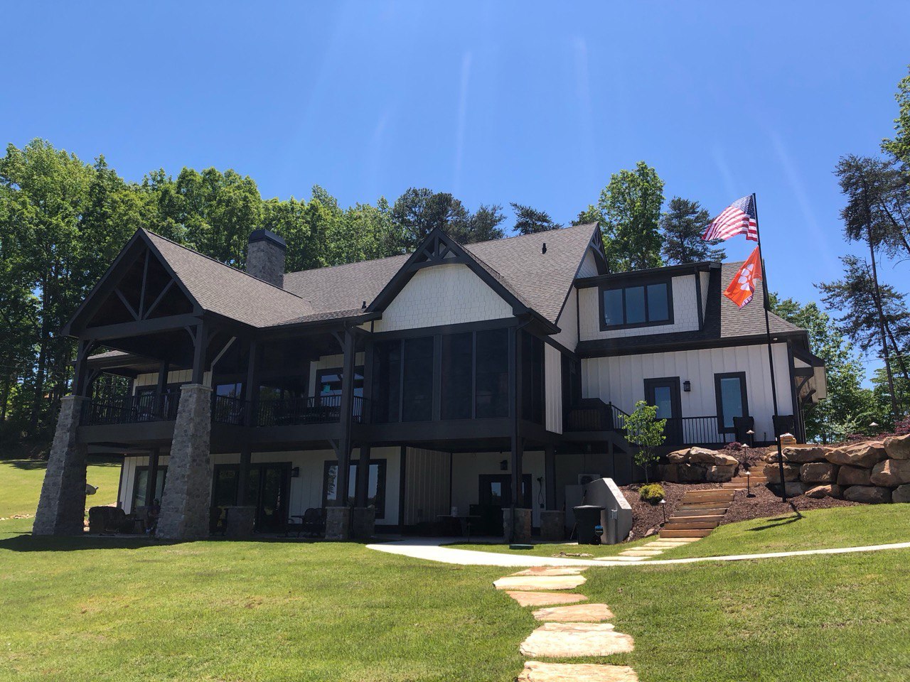 A Phoenix telescoping flagpole flying the American flag at a customer's home