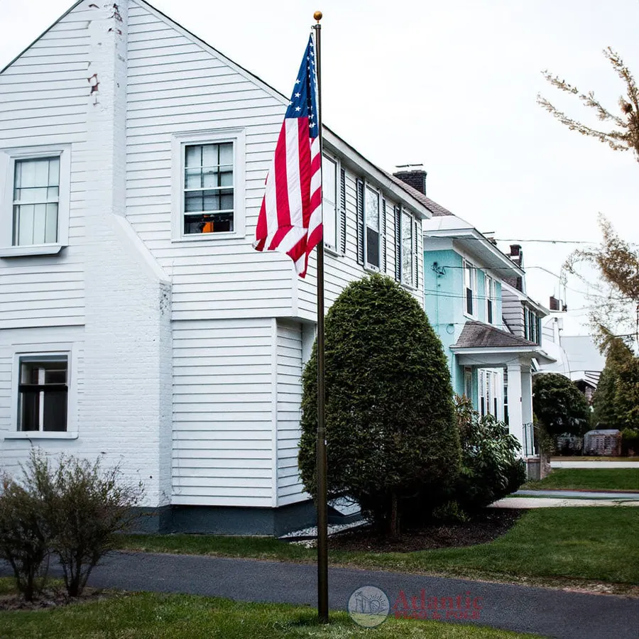 A Phoenix telescoping flagpole flying the American flag at a customer's home