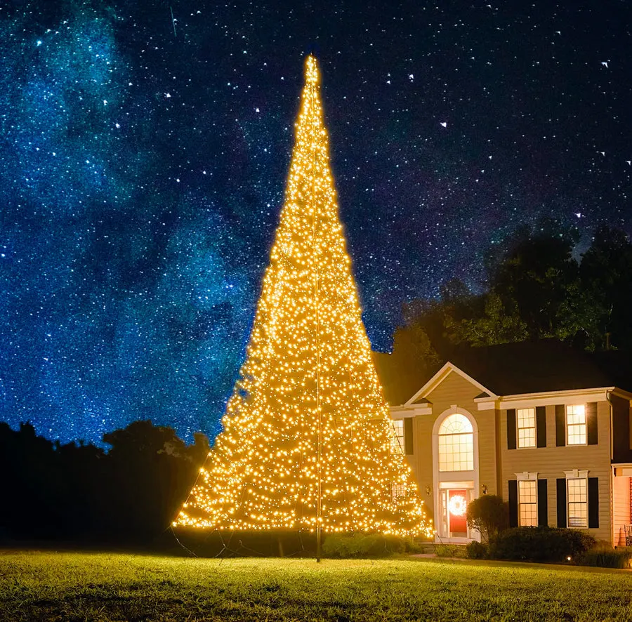 A flagpole Christmas tree lit with warm white LEDs at night
